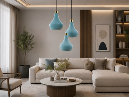 Modern living room with a beige sectional sofa, decorative pillows, and blue pendant lights.