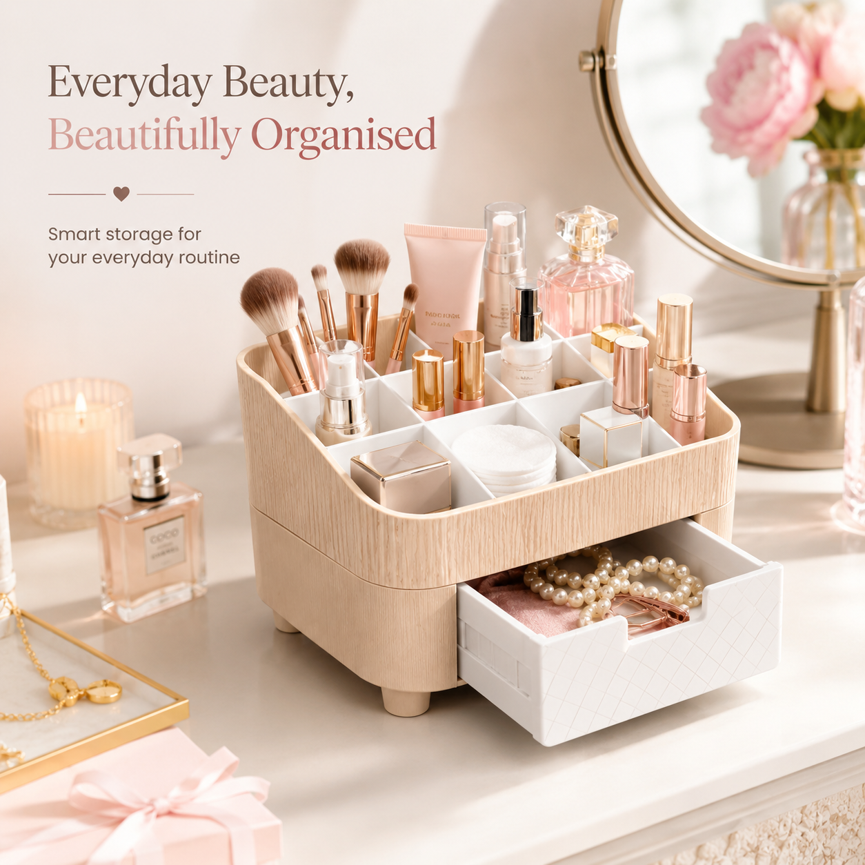 A beige and white multi-compartment makeup organizer with a pull-out drawer, styled on a vanity table with cosmetics, perfume bottles, a mirror, and decorative text reading 'Everyday Beauty, Beautifully Organised'.