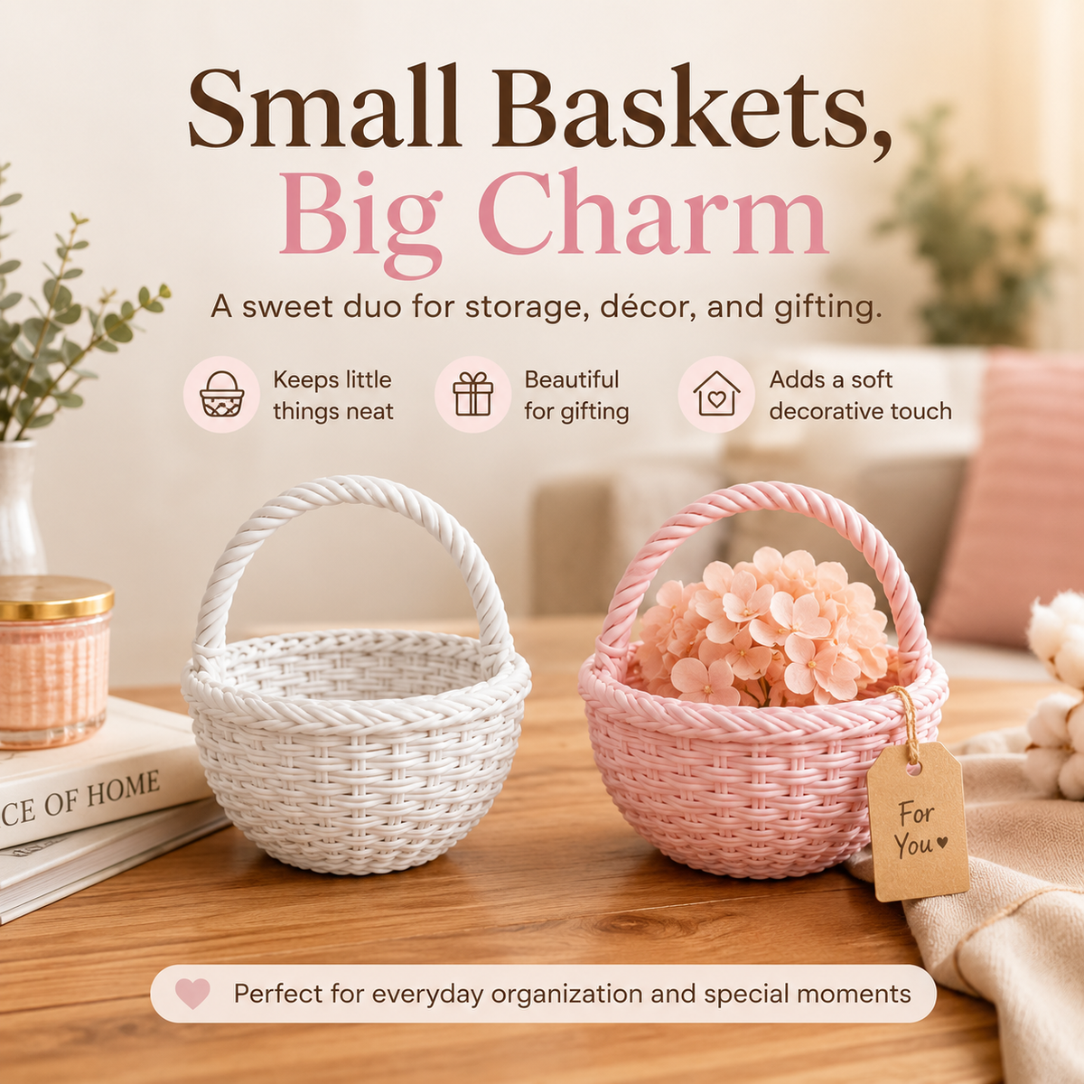 Two small woven storage baskets on a wooden table in a styled home setting. One basket is white and the other is pink, with the pink basket filled with pale pink flowers and a small hanging tag reading 'For You'.