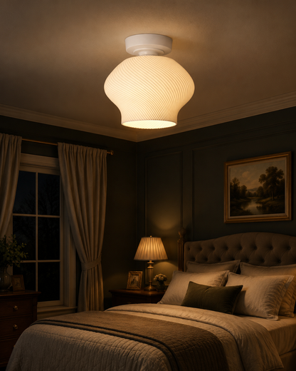 Bedroom with a large ceiling light fixture casting a warm glow.