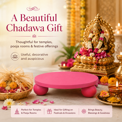 A pink wooden chadava (devotional platform) displayed in a beautifully decorated Indian temple setting with a golden Lord Ganesha idol, lit oil lamps, and floral garlands. The image includes promotional text highlighting its suitability for temples, pooja rooms, and festive occasions.