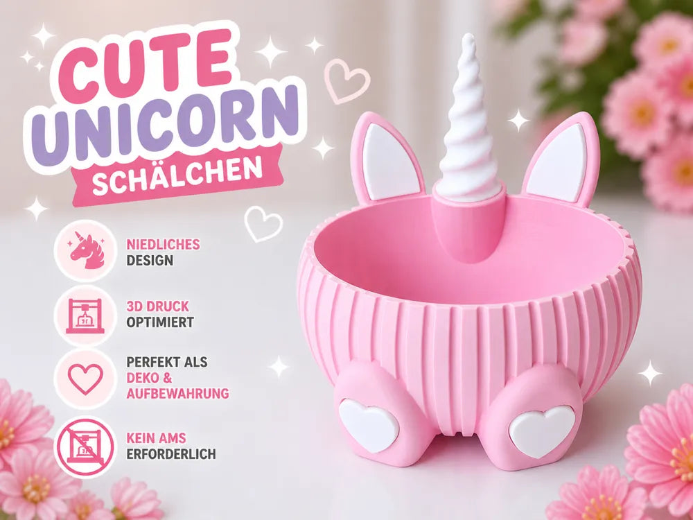 A pink unicorn-shaped storage box with a white horn and ears, shown on a soft light background with flowers and German promotional text on the left.